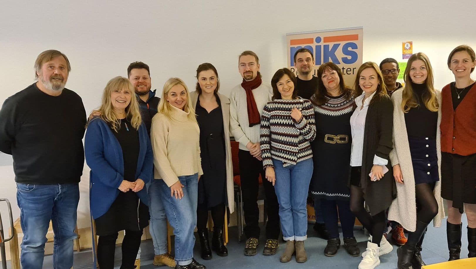 KIME participants gathered for a group photo in front of a MIKS banner.